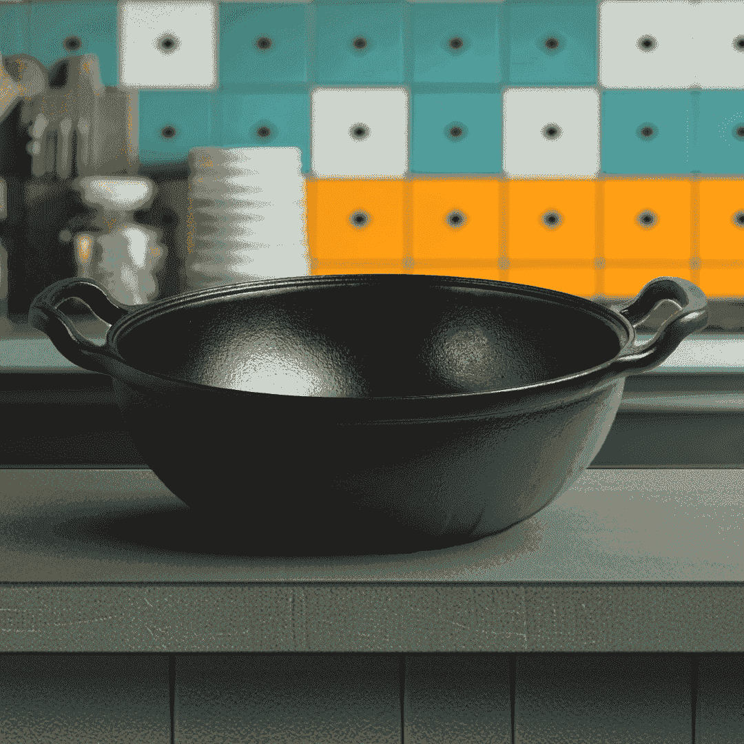 Roca Triton 24cm pre-seasoned cast iron kadai with dual handles on a kitchen counter.