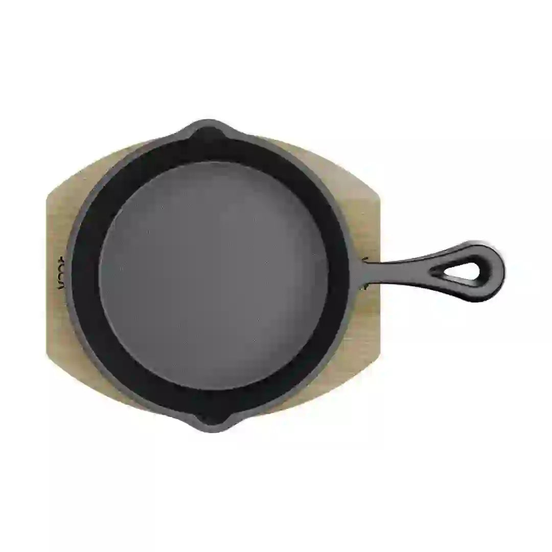 Top view of a 12.5cm pre-seasoned black cast iron skillet resting on a light-colored wooden tray.