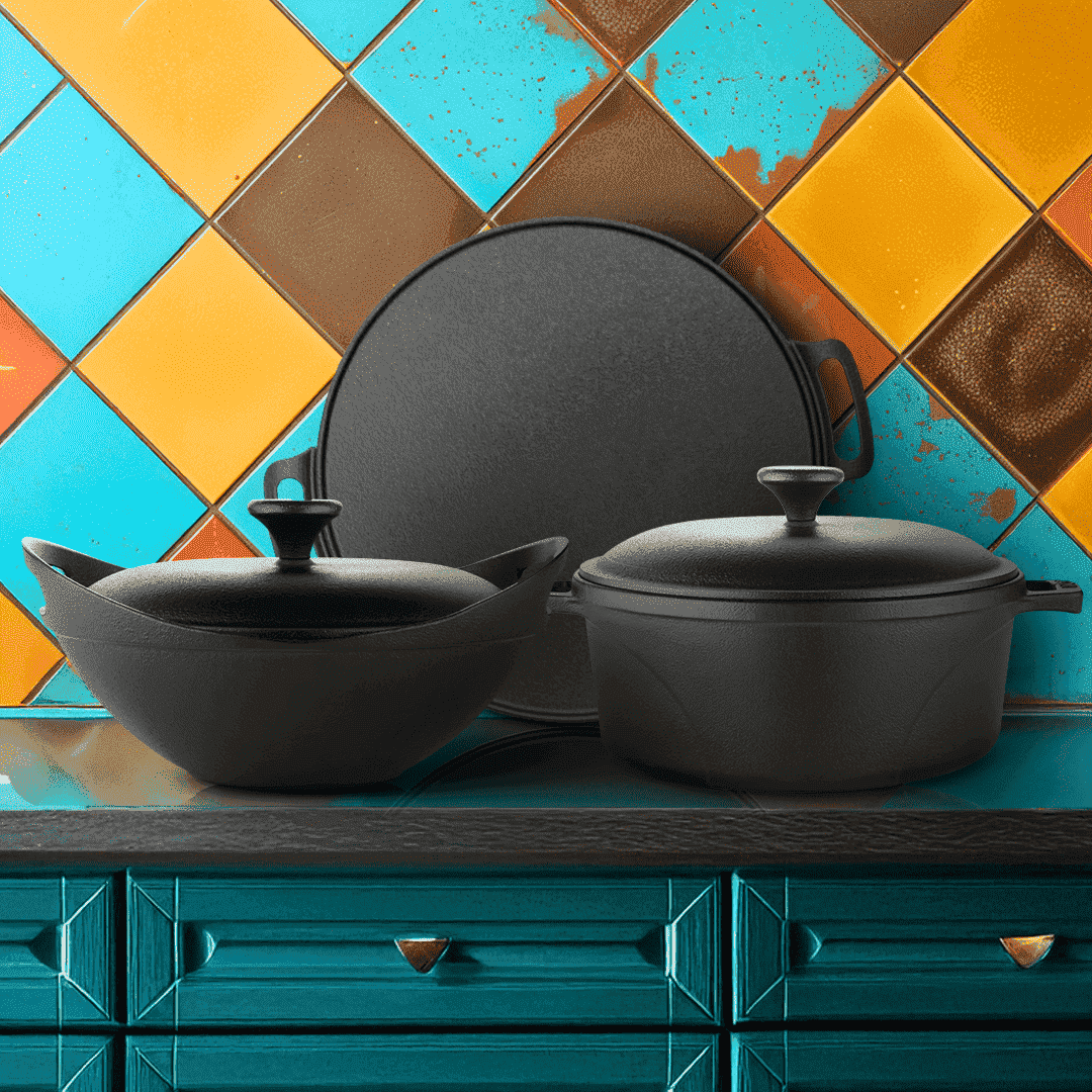 Black cast iron cookware set on a colorful tiled wall background