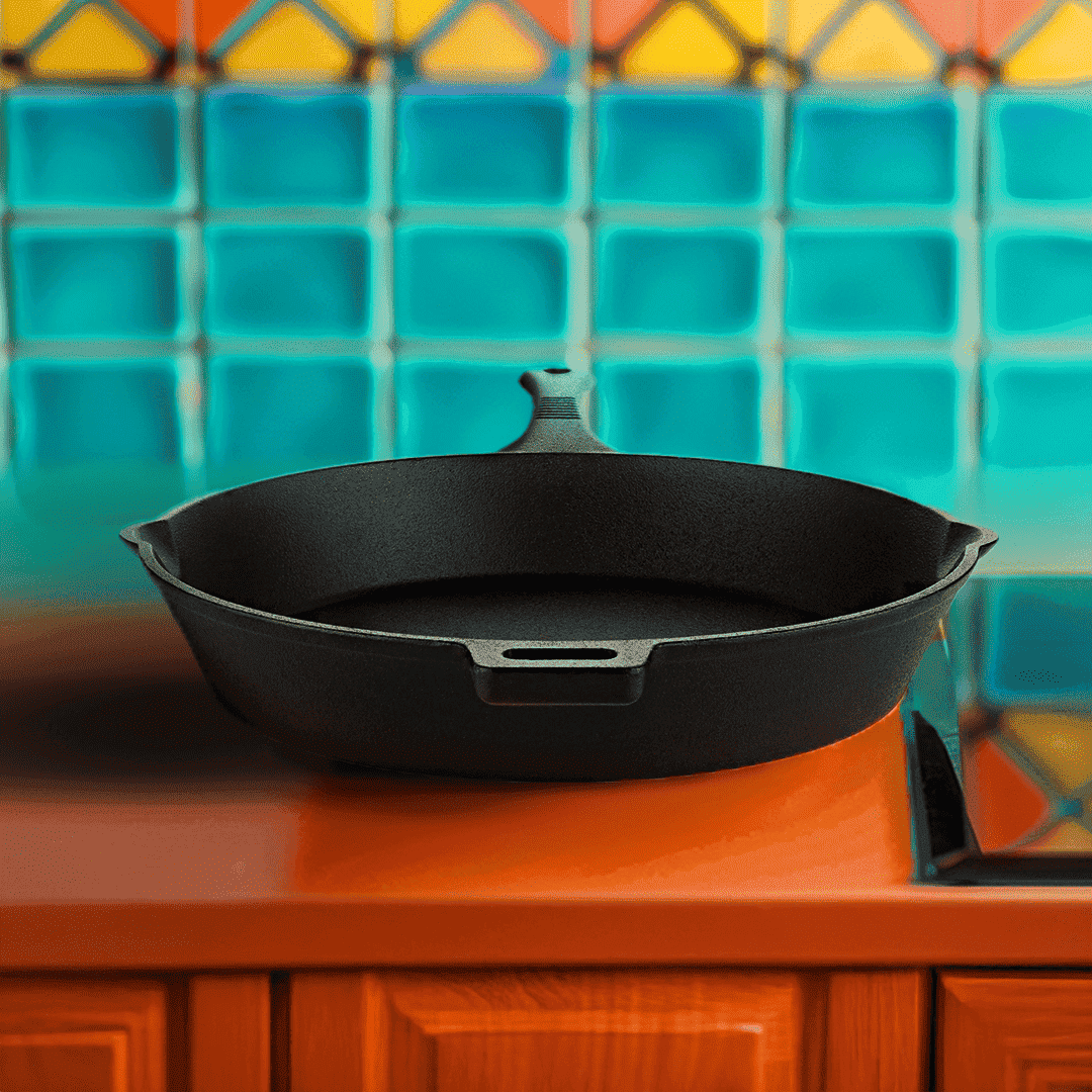 Black cast iron skillet on a wooden surface with a colorful tiled wall in the background