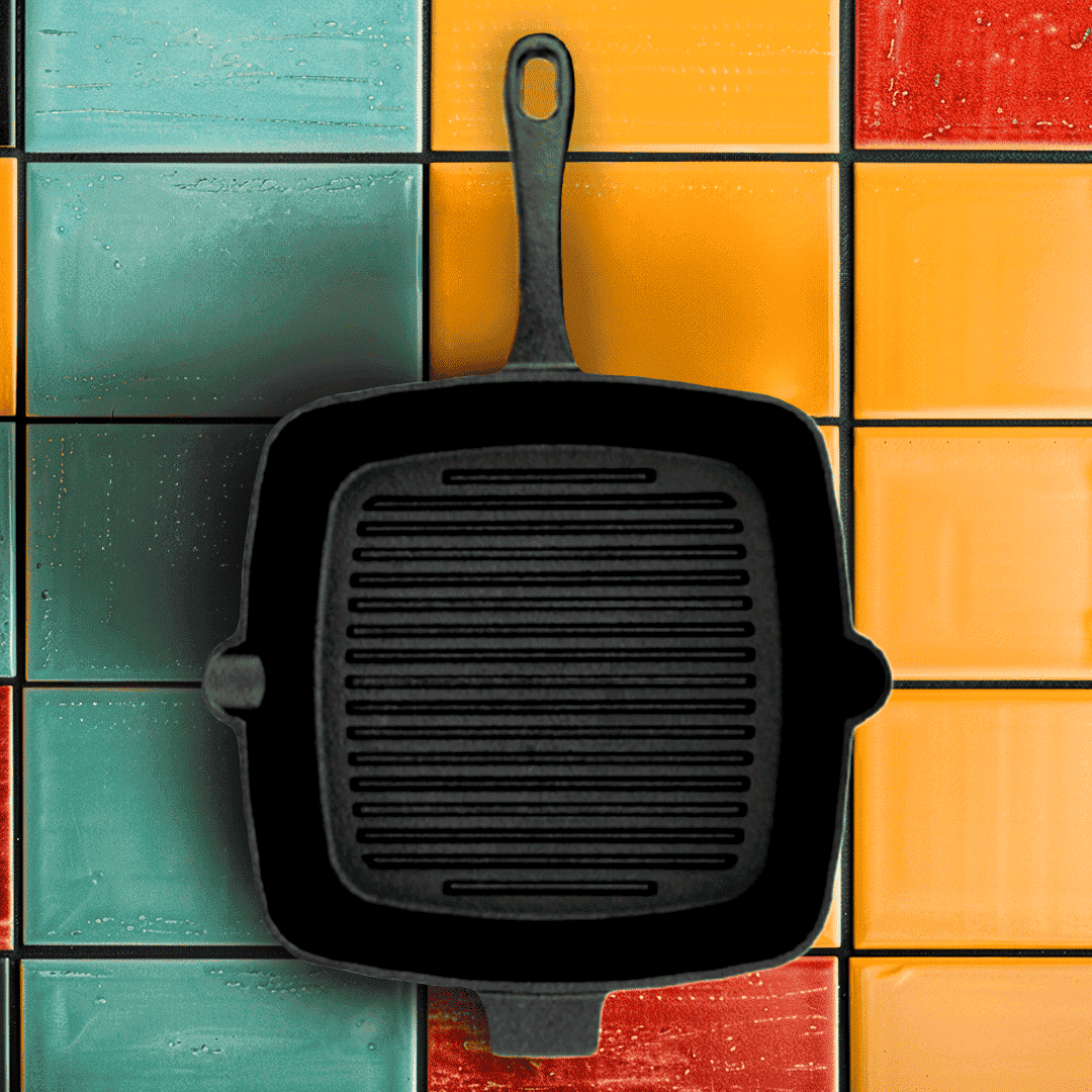 Black cast iron skillet on a colorful tiled background