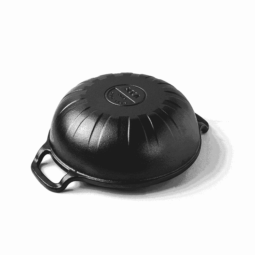Upside-down view of a black 24cm Roca Triton cast iron kadai showing the textured base and handles.
