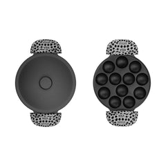Black silicone baking mold with polka dot handles on a white background