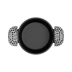 A top-down view of a round black non-stick pan with two handles featuring a black and white cow print pattern, on a solid white background.
