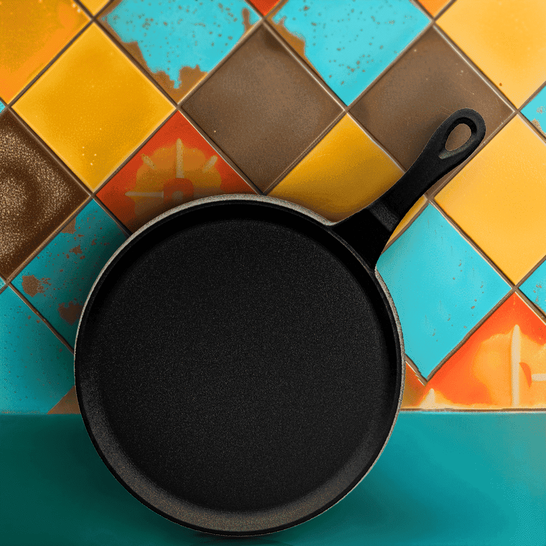 Black cast iron skillet on a colorful tiled surface