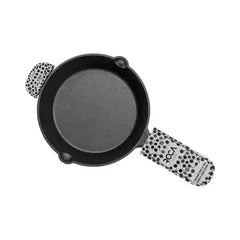 Top view of a 19cm Roca Festive cast iron skillet with patterned cotton handle sleeves.